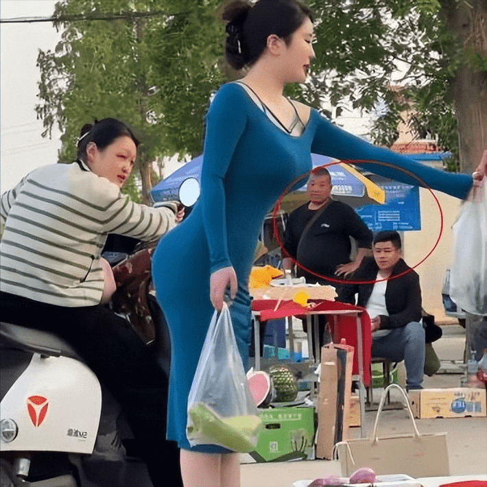 br/> Mới đây, trang Sohu đăng tải loạt ảnh một cô gái ở Giang Tô (Trung Quốc) diện váy ôm body đi chợ mua rau gây chú ý. "Người phụ nữ mặc một chiếc váy dài bó sát đi mua sắm, đẹp thời trang, thanh lịch khiến ai cũng ngoái nhìn", tiêu đề bài viết đăng tải.
