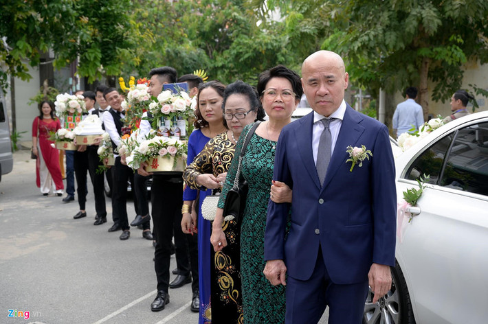 Cha mẹ chú rể dẫn đầu đoàn sinh lễ. Nét mặt hai người ánh lên niềm vui nhưng vẫn không giấu được nét căng thẳng.