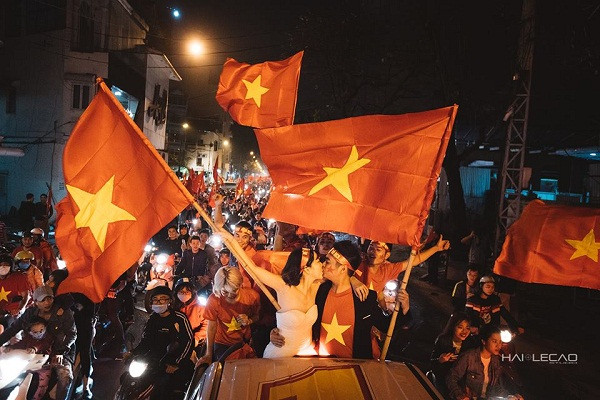Trên chiếc xe bán tải, cặp uyên ương được mệnh danh là "cặp đôi hạnh phúc nhất năm 2018" lưu lại trọn khoảnh khắc hân hoan, ăn mừng cùng những người hâm mộ bóng đá trước chiến thắng của đội tuyển U23 Việt Nam.