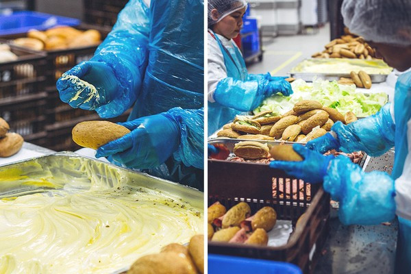 Đội ngũ làm bánh làm việc rất nhanh chóng và hiệu quả. Không cần dùng đến dao, họ sử dụng găng tay rồi phết đều bơ lên các miếng bánh mỳ trước khi kẹp chúng với rau diếp và những lát thịt nguội.