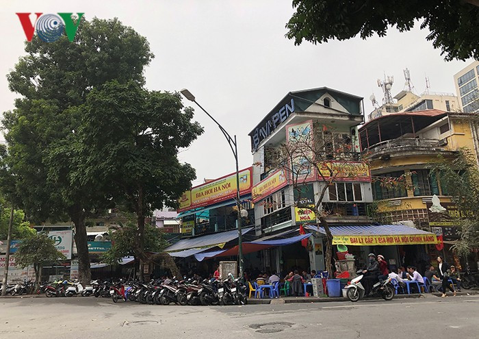 Quán bia vỉa hè Trần Hưng Đạo đối diện Cung Văn hóa hữu nghị Việt Xô, xe máy dựng dưới lòng đường, bàn nhậu choán lối vỉa hè.