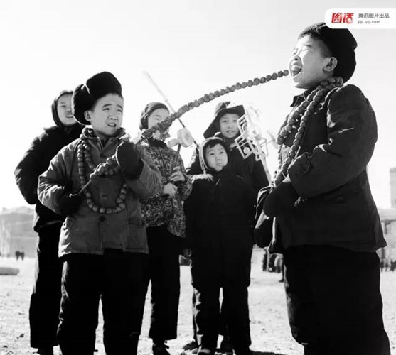 Kẹo hồ lô là một trong những món ăn hấp dẫn trẻ em dịp Tết âm lịch. Ảnh chụp ở Trung Quốc năm 1953.