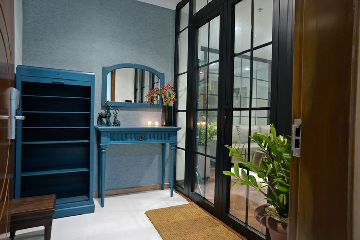 Căn hộ có sảnh vào riêng biệt được đặt kệ để giày và bàn gương với tông xanh đậm đã làm toát lên vẻ cổ điển từ cái nhìn đầu tiên.
