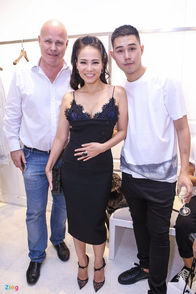 Ca sĩ Thu Minh diện đầm ôm phong cách váy ngủ gợi cảm, được ông xã ngoại quốc hộ tống đến chúc mừng nhà thiết kế thân thiết. Hai vợ chồng cô đang vướng ồn ào kiện công ty bất động sản.