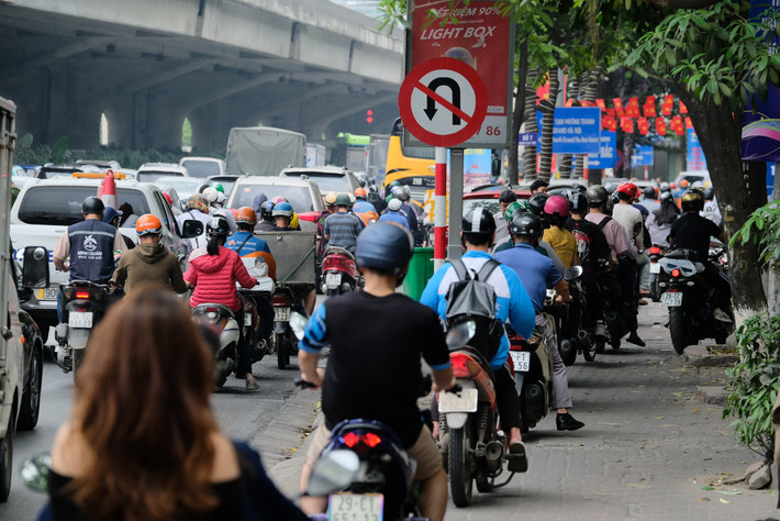 Xe máy tranh thủ đi lên vỉa hè để luồn lách, thoát ùn ứ giao thông.