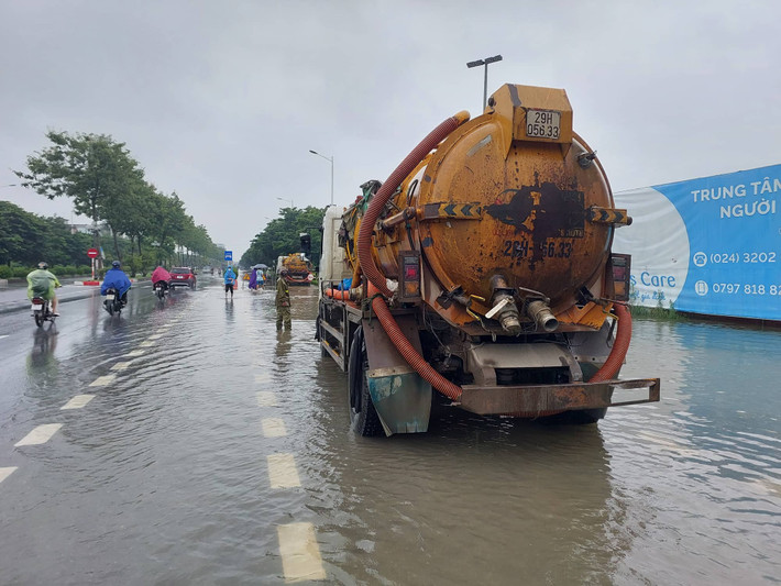 Trước cổng trường Cao đẳng FPT trên đường Trịnh Văn Bô - lối vào cụm công nghiệp Từ Liêm, nhiều xe bồn hút cống đã được huy động để ứng cứu tình trạng ngập lụt kéo dài.