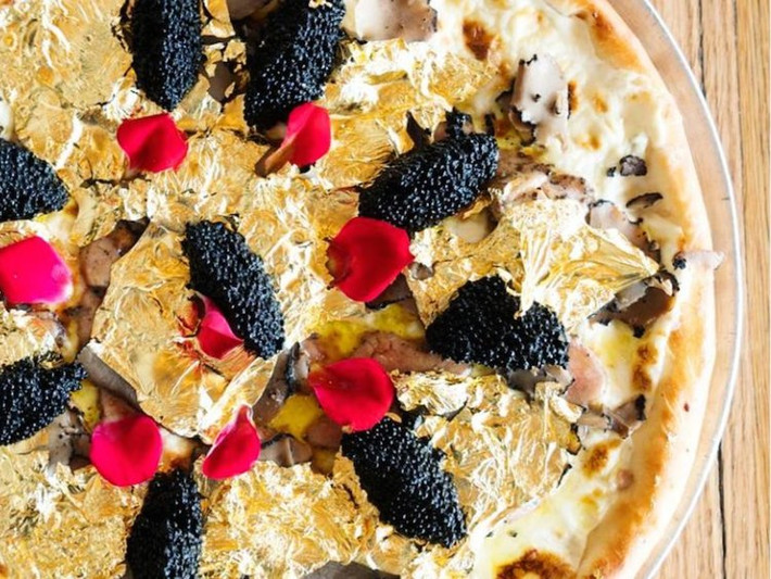Pizza dát vàng của nhà hàng Industry Kitchen ở New York (Mỹ). Bánh được làm từ các nguyên liệu như pho mát Stilton, gan ngỗng, trứng cá Osetra, nấm và một số lá vàng 24 karat lấp lánh từ Ecuador. Món ăn dát vàng này có giá 2.000 USD.