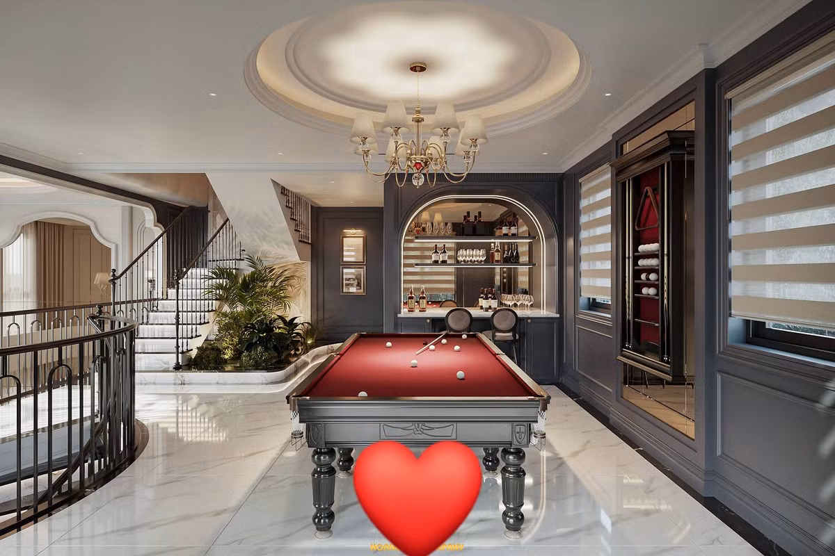 Cạnh đó là quầy bar mini với tủ rượu âm tường thiết kế vòm mềm mại. Ảnh: FBNV