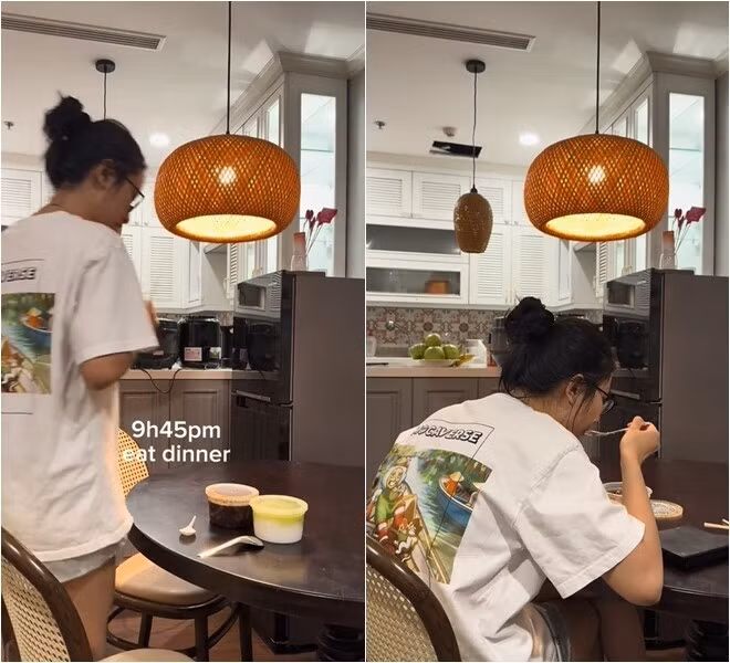 Phòng ăn nối liền bếp, sử dụng đèn mây tre thả trần ánh vàng ấm. Ảnh chụp màn hình