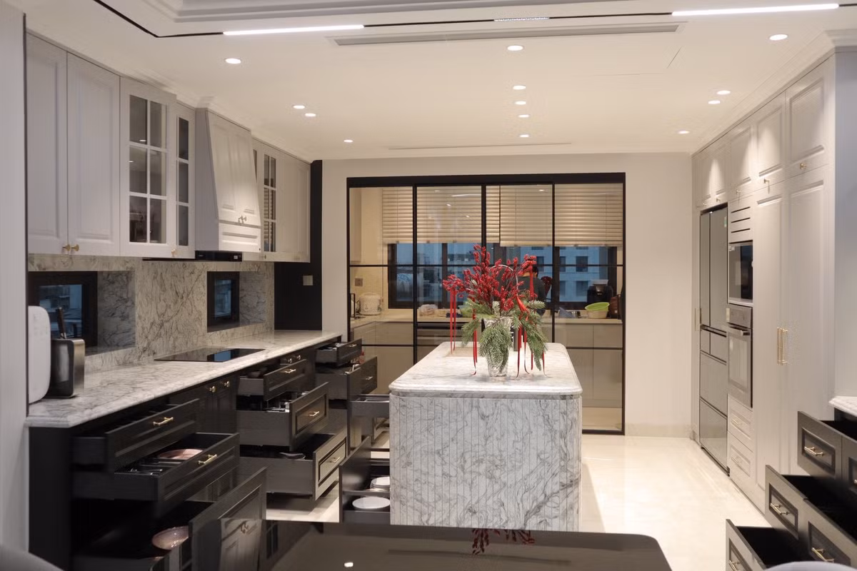 Căn bếp tối giản nhưng sang trọng với gam màu trung tính và hệ thống tủ âm tường kịch trần. Ảnh: FBNV