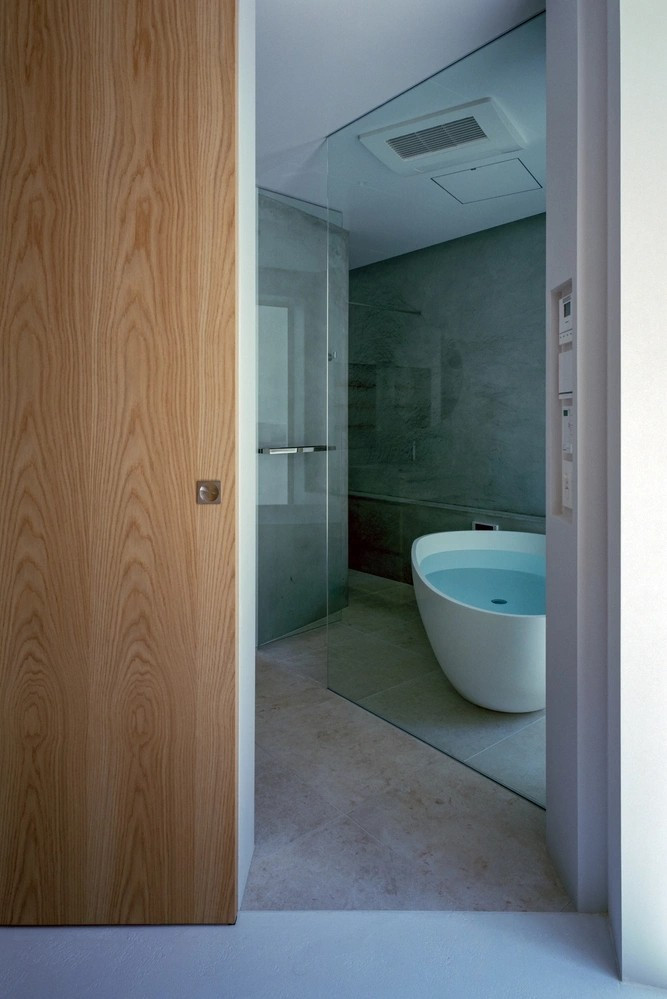 Phòng tắm nối liền sân trong với bồn ngâm độc lập và tường kính trong suốt. Ảnh: Katsuya Taira（studioREM）