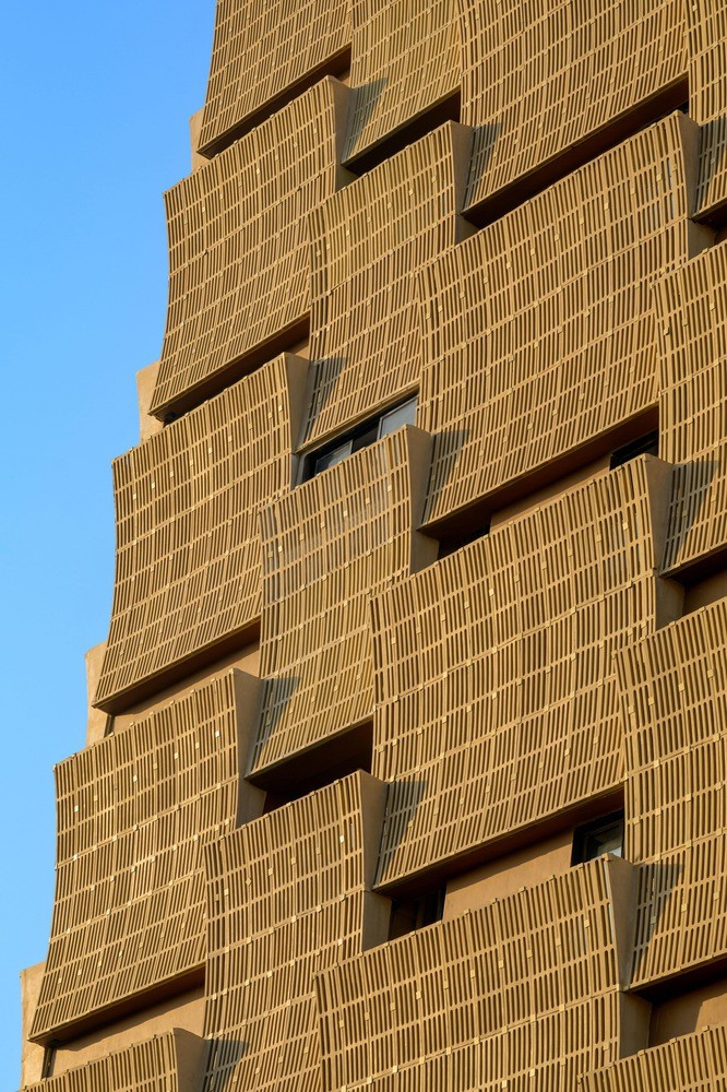 Những bức chắn cong xen kẽ theo chiều ngang và chiều dọc khắp tòa nhà, giúp chắn nắng, tạo ra không gian xanh mở cho mỗi phòng đồng thời mang lại vẻ đẹp độc đáo cho công trình. Ảnh: Vinay Panjwani