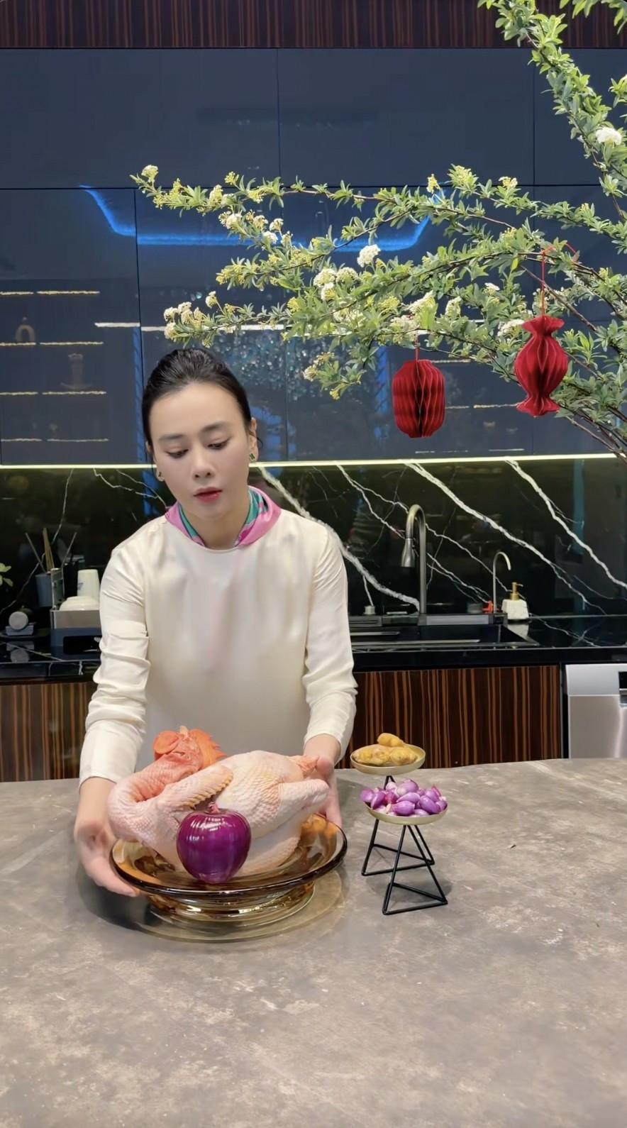 Trong clip, nữ diễn viên tập trung vào chế biến gà luộc cánh tiên và xôi nghệ - những món thường thấy trong mâm cỗ cúng, mâm cơm Tết. Ảnh chụp màn hình