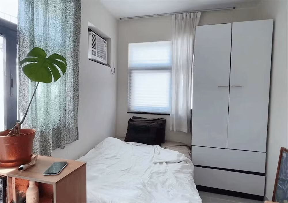 Giường ngủ đặt ở góc có cửa sổ, rất ngăn nắp. Ảnh: Sohu