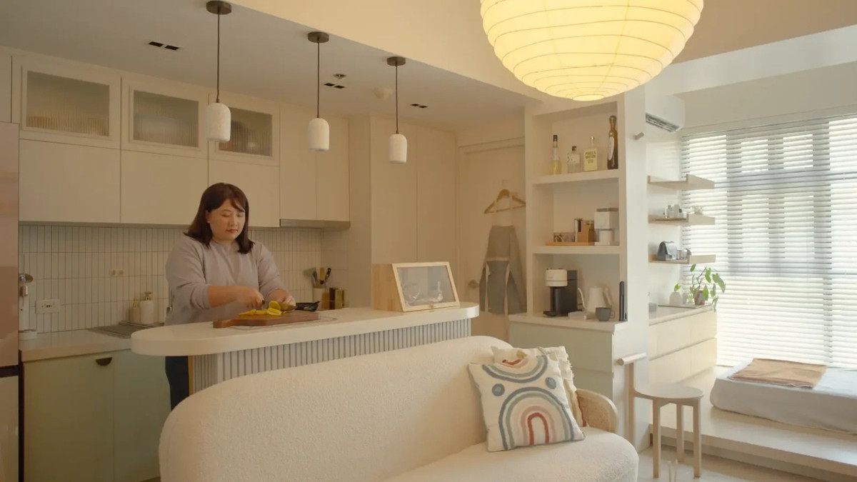 Khu bếp và bàn ăn nối liền hoàn toàn. Bàn quầy bar hẹp đặt sau sofa vừa là bàn ăn cho 2–3 người, vừa đóng vai trò đảo bếp. Ảnh: Stackedhomes