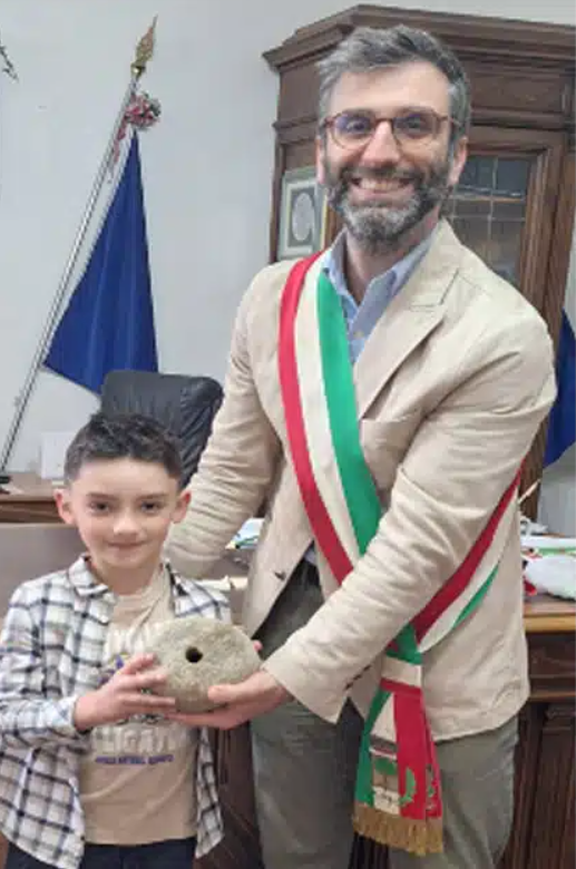 Nicolò Naturani với cảm xúc sâu sắc và niềm tự hào, đã trao hiện vật cho thị trưởng Carpaneto, Andrea Arfani. Sau đó, hiện vật được chuyển giao cho Cục Giám sát Khảo cổ để phân tích. Ảnh: @Bảo tàng Khảo cổ học Thành phố Piacenza.