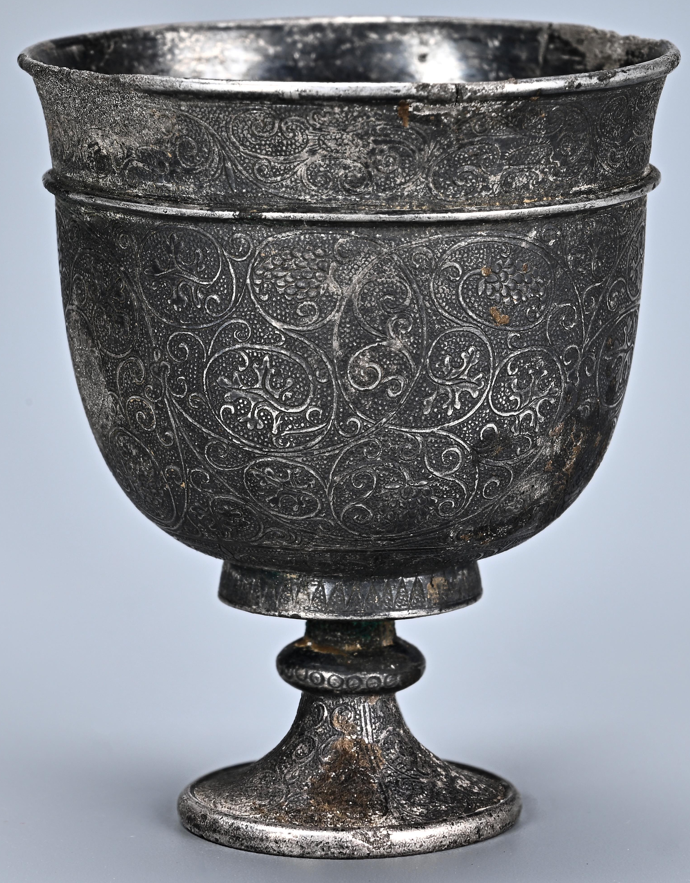 Ngoài ra, một bộ đồ dùng bằng bạc, bao gồm một chiếc bình ba chân và một chiếc cốc có chân đế, mang họa tiết nho và kim ngân hoa đặc trưng của truyền thống nghệ thuật vùng Tây Vực. Ảnh: @Viện Khảo cổ học tỉnh Thiểm Tây.