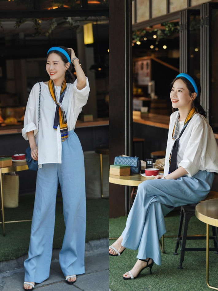 Vẫn là set áo sơ mi/blouse + quần ống rộng nhưng nếu bạn để lệch 1 bên vạt áo, thêm chiếc khăn quàng cổ, bờm tóc thì outfit sẽ ưng mắt hơn rất nhiều.