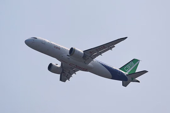Một máy bay chở khách thân hẹp COMAC C919 bay trên bầu trời. Ảnh: Reuters.