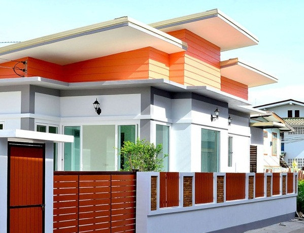 Tường rào gỗ màu đỏ giúp ngôi nhà cấp 4 mái lệch thêm phần nổi bật. Ảnh: Thietkethicongnhadep.