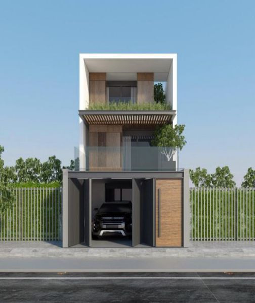Nhà 2 tầng có sân để ô tô với kiến trúc đơn giản mà cực kỳ hiện đại. Tầng 2 có kính làm lan can giúp phần mở rộng không gian thông thoáng ngôi nhà. Ảnh: Nhabinhduong.