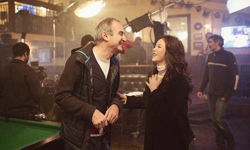 Lý Nhã Kỳ tươi rói bên đạo diễn Olivier Assayas trên phim trường