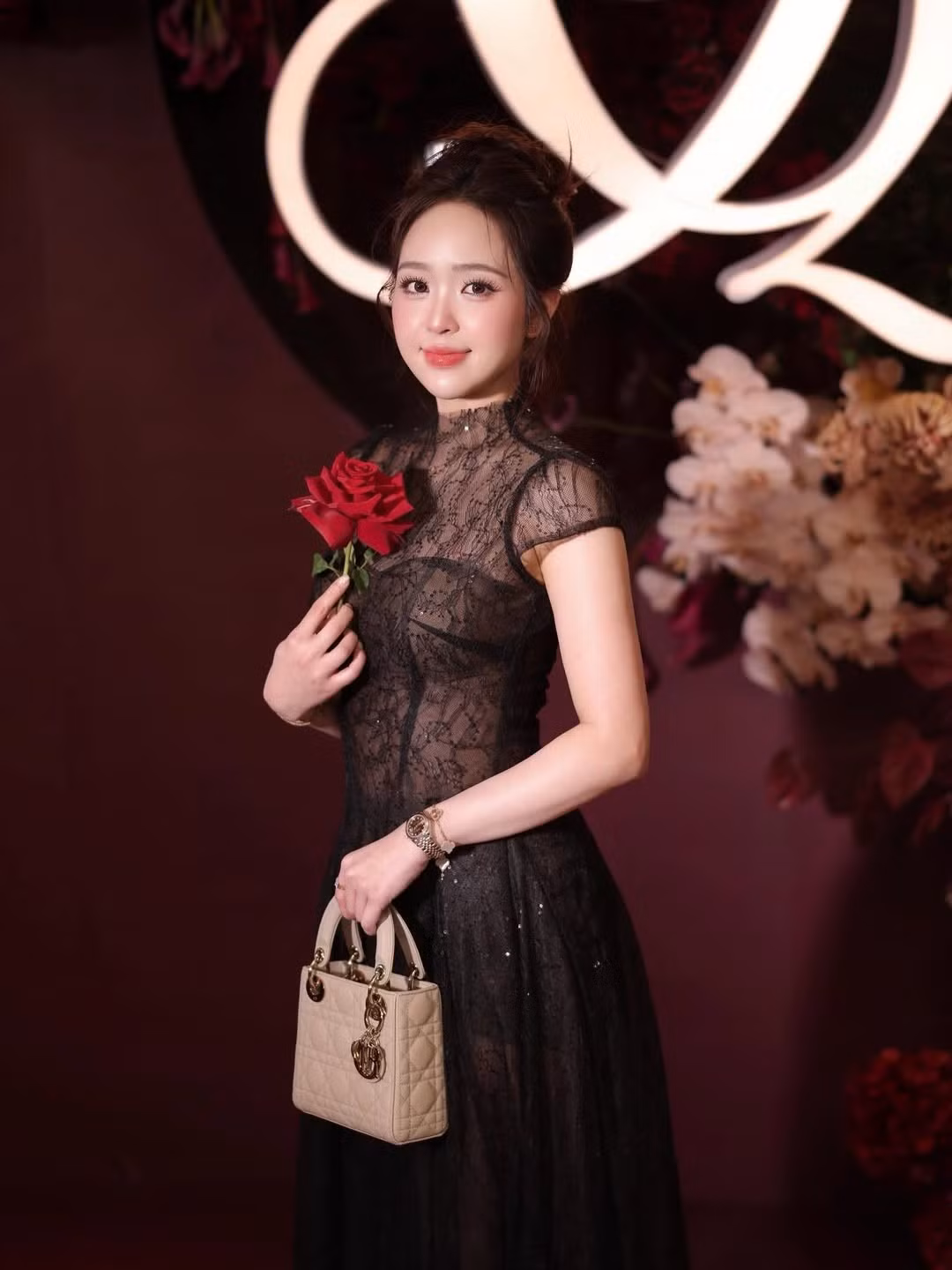 Điểm nhấn của bộ ảnh chính là cách cô nàng thả dáng bên những đóa hoa hồng nhung đỏ thẫm. Dưới ánh đèn vàng ấm áp của không gian tiệc cưới, làn da trắng sứ và gương mặt thanh tú của Phương Anh càng thêm nổi bật. (Ảnh: IGNV)