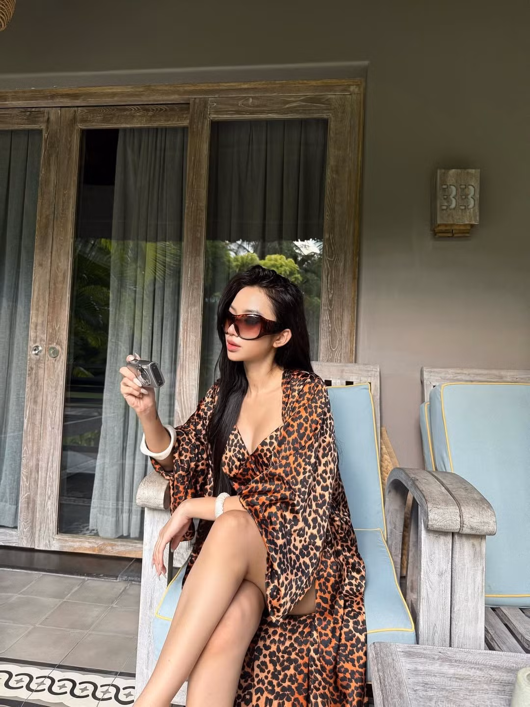 Quỳnh Như còn khéo léo phối hợp với phụ kiện như kính râm bản lớn sang chảnh, và đặc biệt là chiếc máy ảnh cổ điển, tạo nên tổng thể vừa hoài cổ vừa hiện đại. (Ảnh: IGNV)