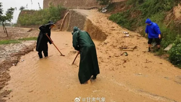 People clear a road after heavy rain in Longnan City, Gansu Province, China. Photo: China Daily/Asia News Network. tq1.png