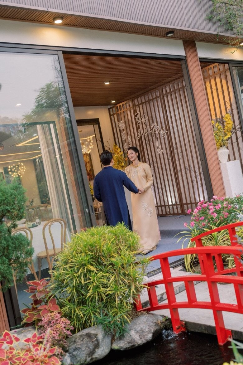 Chiếc cầu gỗ nhỏ sơn đỏ bắc qua mặt hồ, kết nối khu vườn với khu nhà chính. Ảnh: FBNV