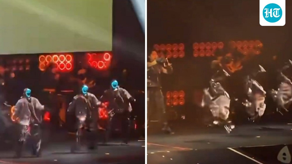 Khi ca khúc Open Fire vang lên, sáu “vũ công” trong trang phục ánh bạc bước ra sân khấu, ban đầu khiến khán giả lầm tưởng đó là người thật đeo mặt nạ Cyberpunk.