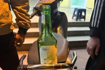 Đi xe máy vi phạm, rút hai vỏ chai thủy tinh ném vào Công an