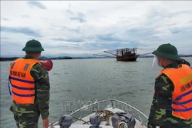 Cán bộ chiến sỹ Biên phòng Quảng Bình kêu gọi, hướng dẫn tàu, thuyền vào neo đậu tại bến thuyền, cảng cá đảm bảo an toàn. Ảnh minh họa: TTXVN phát