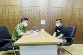 Trần Minh Tuấn tại cơ quan công an.