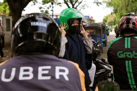 Grab không phạm luật khi mua Uber tại Việt Nam 