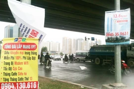 Nhếch nhác biển quảng cáo “đu” cột điện, đèn đường