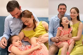 Biểu cảm của con gái Lan Phương khi chụp ảnh cùng bố mẹ