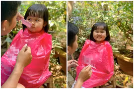 Biểu cảm dễ thương của em bé được bố cắt tóc