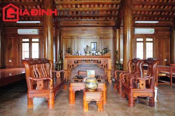 Phòng khách ngôi nhà gỗ của đại gia Lê Thanh Thản bày biện 2 bộ bàn ghế minh triện gỗ hương. Trong đó, Bộ bàn ghế minh triện gỗ hương đặt chính giữa được chạm khắc Tùng-Cúc-Trúc-Mai... Ảnh: Gia đình Việt Nam.