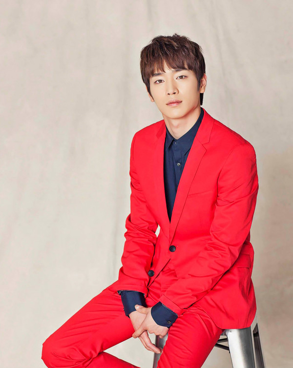 Seo Kang Joon diện vest đỏ sặc sỡ trên nền áo sơ mi tối màu.