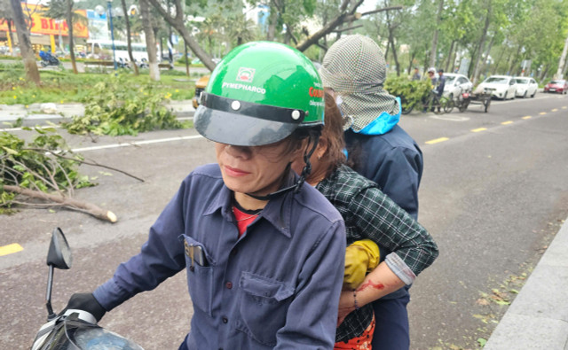 Một phụ nữ bị thương được người dân đưa đi cấp cấp cc.jpg