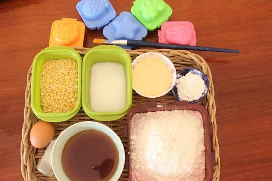 1. Nguyên liệu chuẩn bị. Phần vỏ bánh trung thu: Bột mì, đường, dầu ăn, baking soda và một lòng đỏ trứng gà. Phần nhân: Đậu xanh không vỏ, đường, bột bánh dẻo, muối, dầu ăn và nước hoa bưởi. Phần trang trí: Hạt đậu đen, sữa tươi, lòng đỏ trứng, nước hàng, dầu mè. Ảnh: toinayangi.vn. .