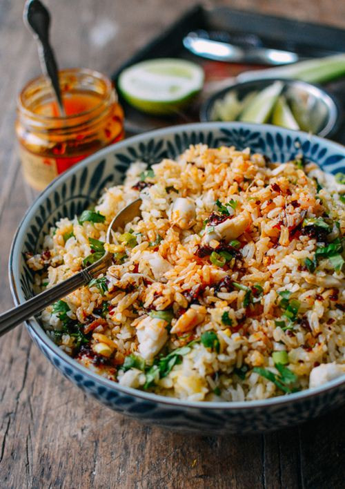 Cho trứng vào chảo cơm, đảo nhanh tay để trứng báo đều vào từng hạt cơm. Sau đó, cho thịt cua vào đảo đề lên. Quan sát thấy thịt cua đã nóng lên thì bạn cho hành lá và rau mùi thái nhỏ vào rang thêm một lúc nữa thì tắt bếp. Ảnh: Eva.vn.