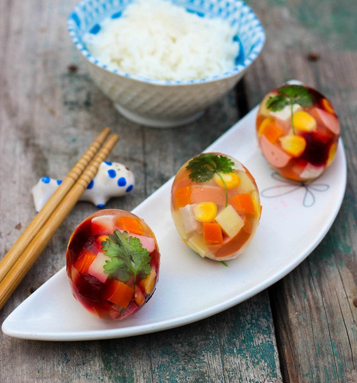 Công đoạn khó nhất là lấy vỏ trứng nguyên quả, chỉ đục lỗ nhỏ trên đầu trứng để rót thịt đông vào khi đã nấu xong. Để tủ lạnh và dùng dần, mỗi khi ăn, chỉ đơn giản đập vỏ trứng ra là đã có những quả trứng thịt đông ngon tuyệt đẹp mắt. Ảnh: Gocamthuc.