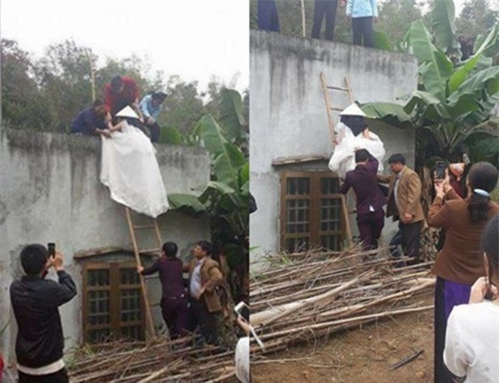 Cô dâu leo tường vào nhà trai. Cách đây mấy ngày, clip cô dâu leo tường vào nhà chú rể thu hút chú ý của cộng đồng mạng. Được biết, clip ghi lại tại Bắc Kạn. Cư dân mạng đã đoán già đoán non rằng cô dâu mang bầu nên phải đi cửa sau. Tuy nhiên, gia đình này không có cửa sau và cô dâu đã phải leo thang vào nhà. Ảnh: Netlife.