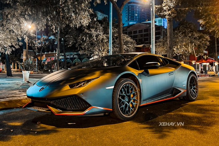 Khác với tông cam nguyên bản, chiếc Lamborghini Huracan tại Việt Nam này hiện mang trên mình bộ cánh màu xám mờ sành điệu, kết hợp với một vài điểm nhấn màu cam quanh xe tạo sự tương phản thú vị.