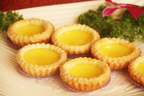Bánh tart trứng. Biến tấu độc đáo cùng món bánh ngọt của người Bồ Đào Nha. Thực chất món bánh này được du nhập qua Hồng Kông vào thập niên 1940 và thường được bán trong các trà quán ở xứ Cảng thơm. Ngày nay, món bánh trứng nướng này trở nên phổ biến trong trào lưu đồ ăn nhanh của giới trẻ.