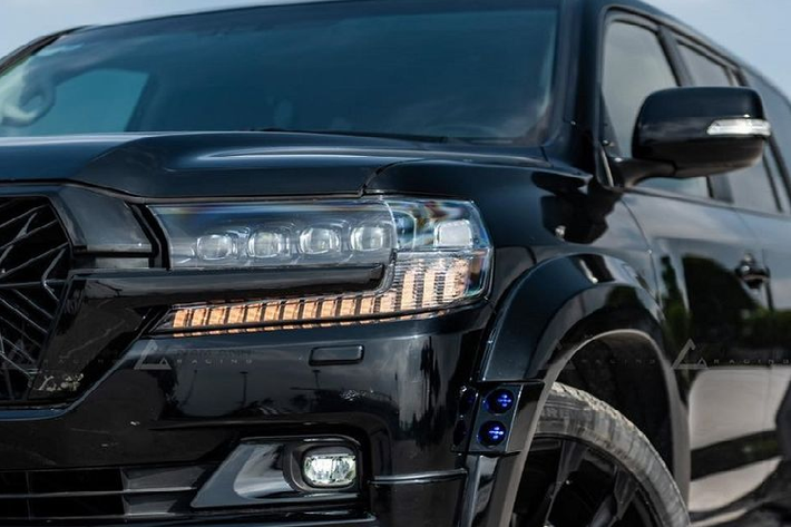Gói độ đã giúp chiếc xe SUV Toyota Land Cruiser đời cũ trở nên hầm hố và cá tính hơn hẳn, ấn tượng nhất là phần đầu xe với cản trước mới tích hợp dải LED ở dưới cùng và cụm đèn pha full LED dạng 4 mắt mới.