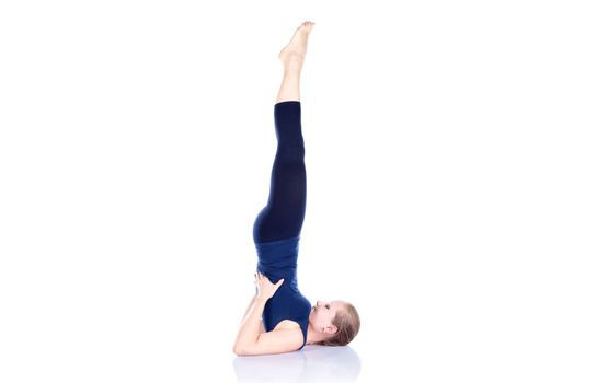 Để thực hiện bài tập Sarvanga Asana, trước hết, bạn cần nằm ngửa trên sàn nhà, co hai đầu gối lên áp sát vào ngực. Ảnh: yogajournal.