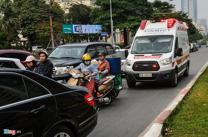 Xe cứu thương đang hú còi khẩn cấp, chạy trong làn của xe buýt nhanh cũng khó lòng di chuyển khi các phương tiện khác dừng đèn đỏ tràn sang.